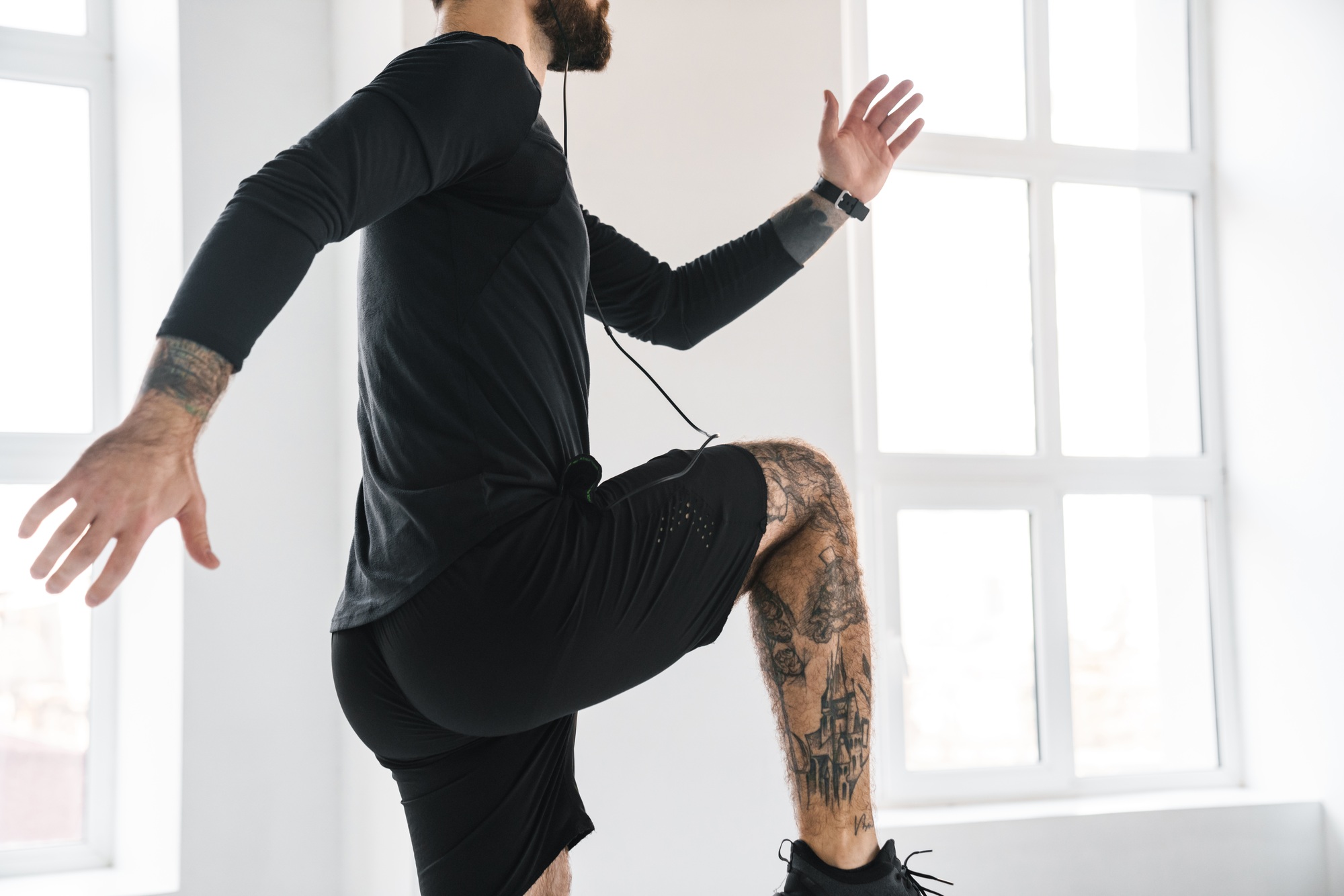 Young brunette bearded white man in sportswear